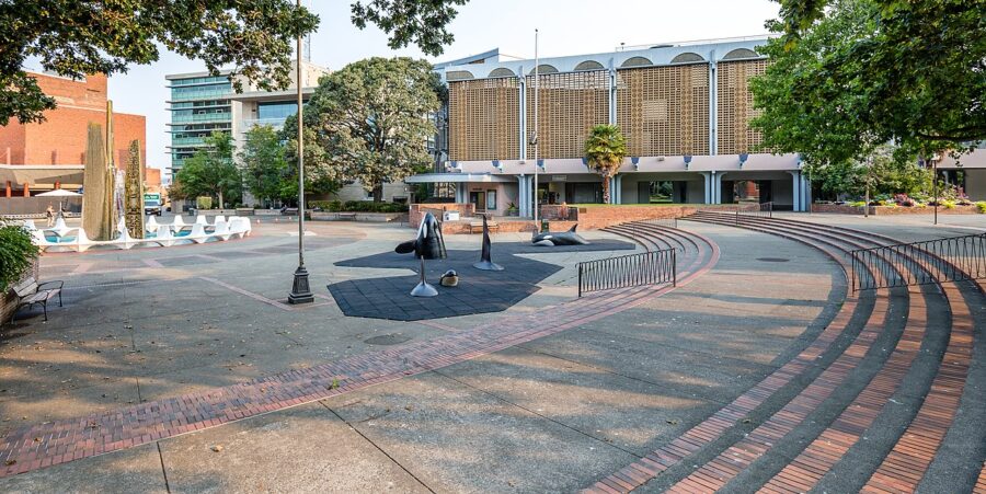 Centennial Square park in Victoria, showcasing a skateboard ramp surrounded by benches for public seating.