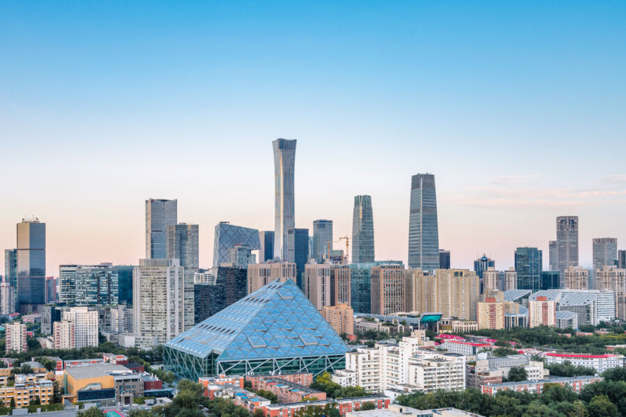 Panoramic view of Beijing's Central Business District at dusk, showcasing city lights and skyline against a twilight sky