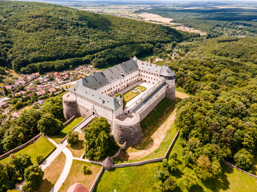 Aerial view of Červený Kameň Castle in Slovakia, showcasing its beautiful garden and park surrounding the historic structure