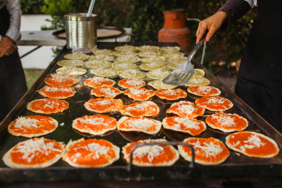 Chalupas poblanas, a spicy Mexican snack, served in Puebla City, featuring a crispy tortilla topped with various ingredients