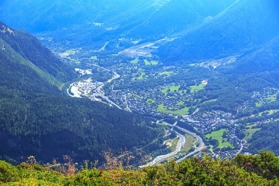 Scenic view from a mountain top overlooking Chamonix Valley and surrounding mountains in France.
