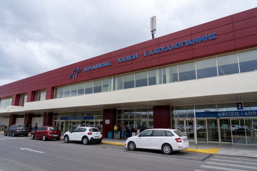 Exterior of Chania International Airport showcasing modern design with glass and reddish-brown panels.