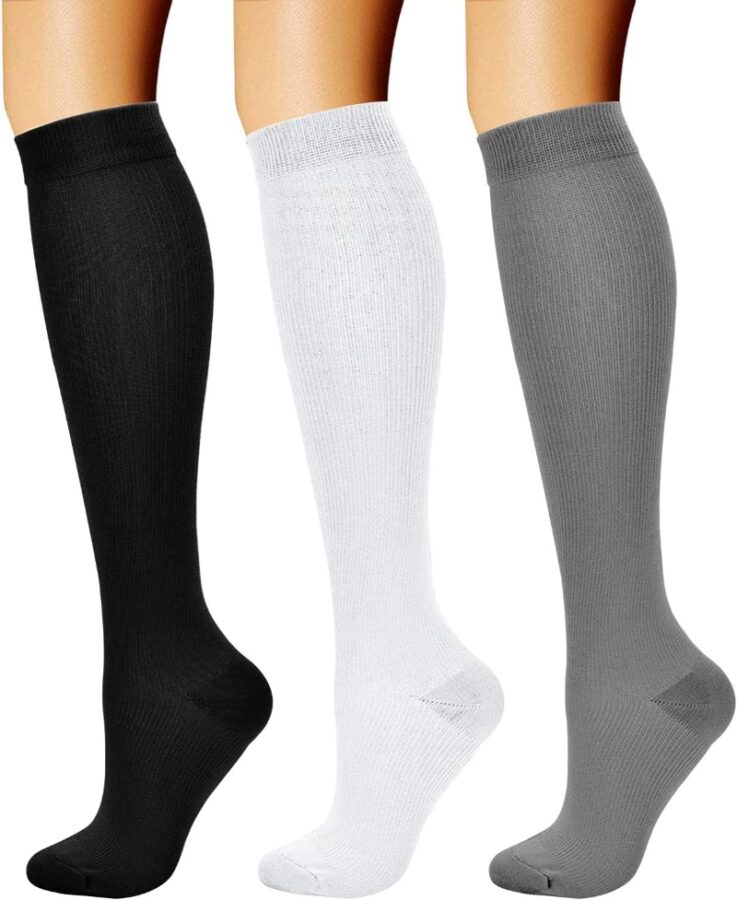 Three pairs of CHARMKING women's knee-high compression socks in various colors displayed together.
