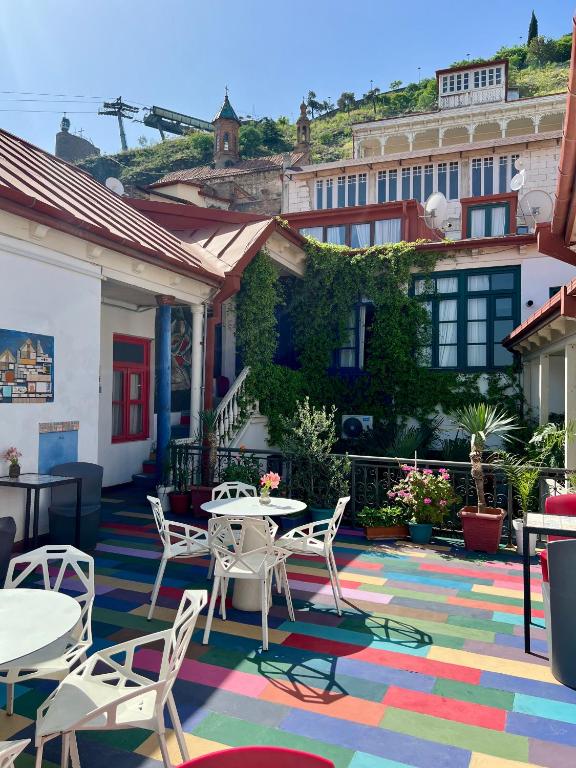 Colorful outdoor seating area with tables and chairs at Check Point Hotel Tbilisi, perfect for enjoying the fresh air.
