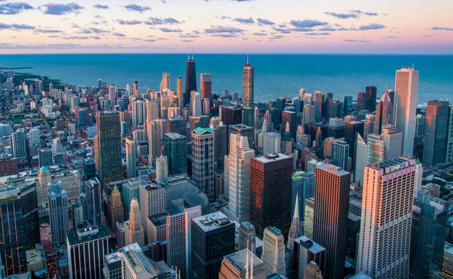 Aerial view of Chicago skyline at sunset with Lake Michigan.