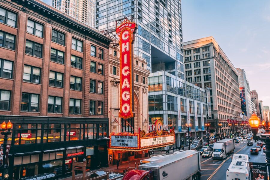 Iconic Chicago Theater facade with vibrant marquee and bustling city street scene.