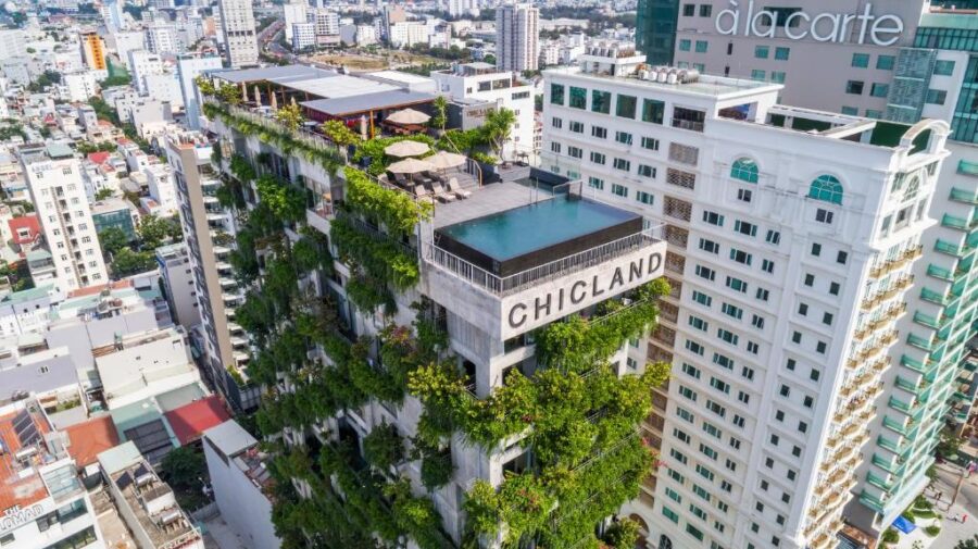 Chicland Danang green hotel with rooftop infinity pool and vertical garden overlooking city skyline.
