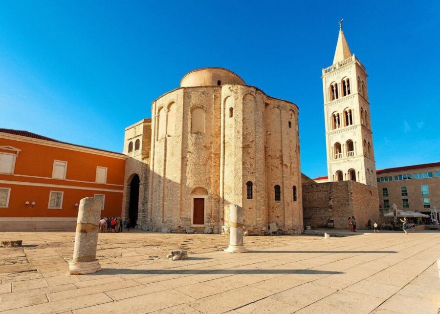 The Church of St. Donatus, an ancient structure, stands prominently in the center of Zadar, Croatia, surrounded by town life.
