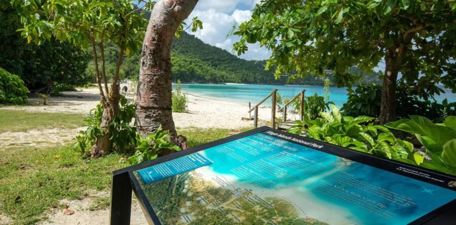 Beach sign at Cinnamon Bay Campground, depicting a beach scene in St. John, U.S. Virgin Islands.