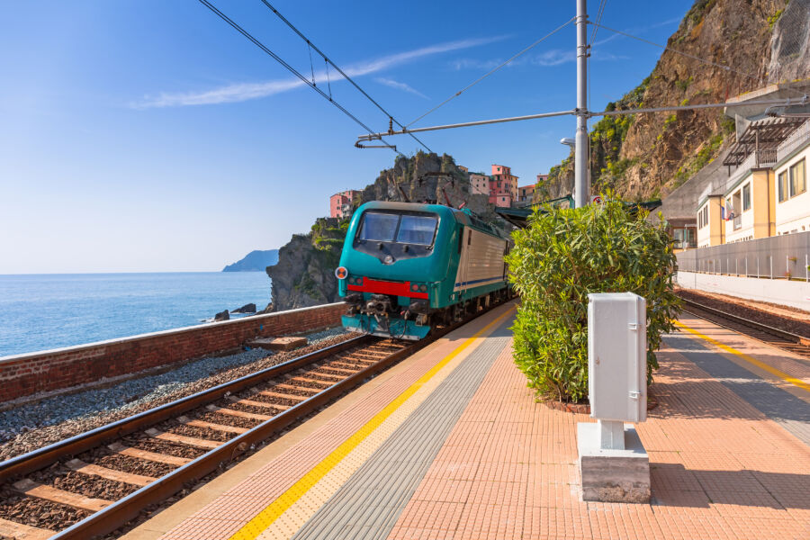 Scenic train station at Manarola, Cinque Terre National Park, Italy, with charming buildings and stunning coastal landscape.

