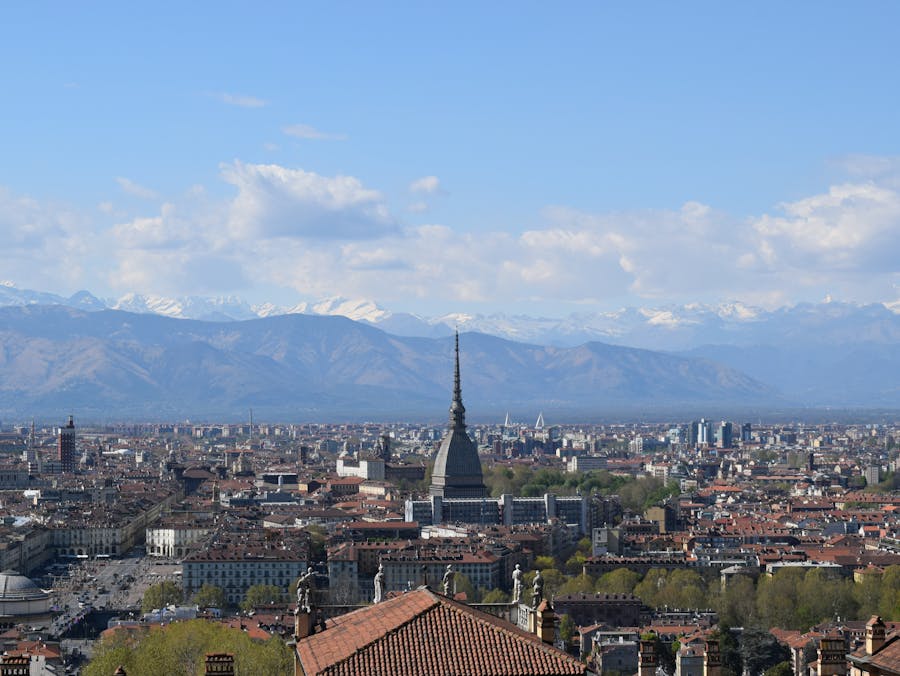 Turin skyline with Mole Antonelliana spire and Alps in the background.