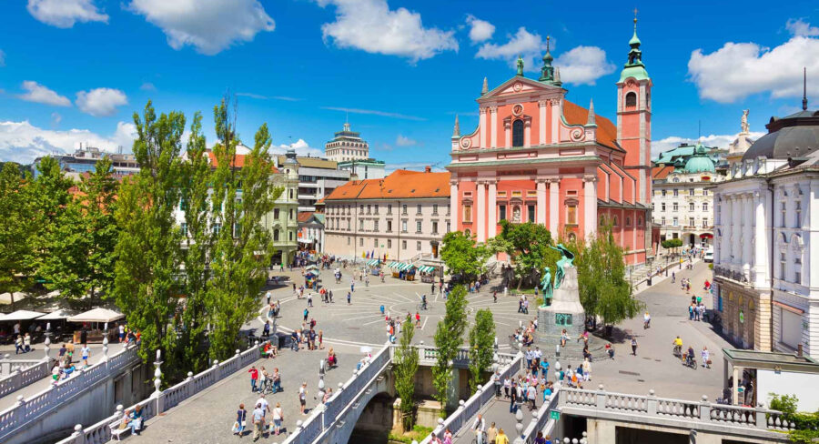 Prešeren Square, Ljubljana: sunlit plaza with pink Baroque church and bell tower.