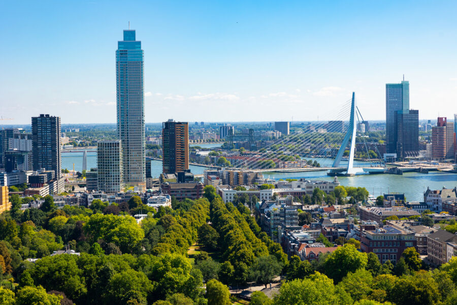The Erasmus Bridge in Rotterdam, Netherlands, elegantly arches over the harbor on a bright summer day, highlighting its design