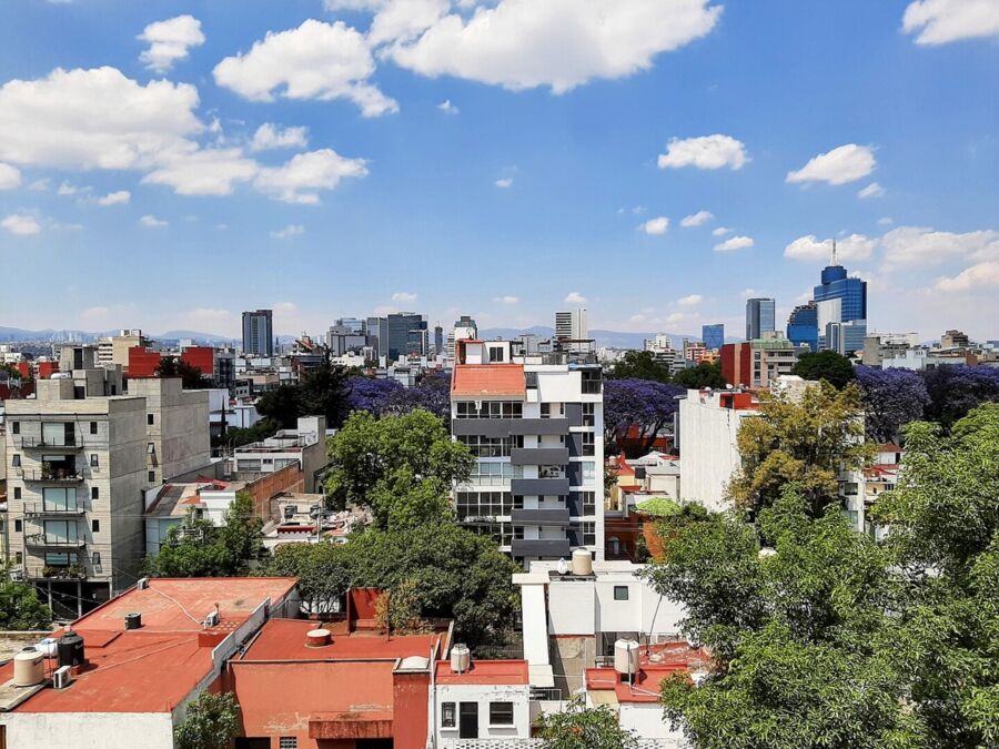 Vibrant Mexico City rooftops, modern architecture, skyscrapers, and blue sky.