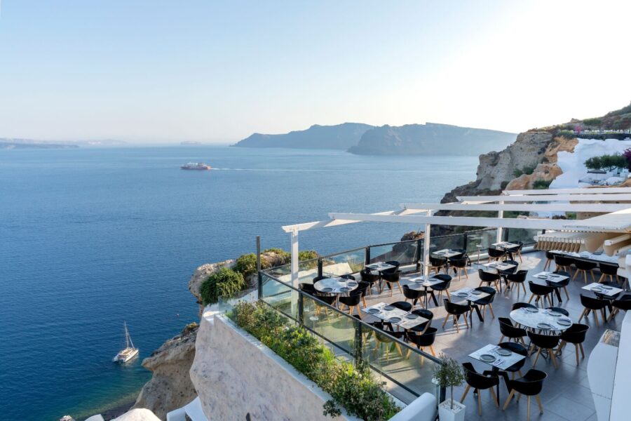 Cliffside restaurant with ocean view, modern design, capturing serene natural beauty.