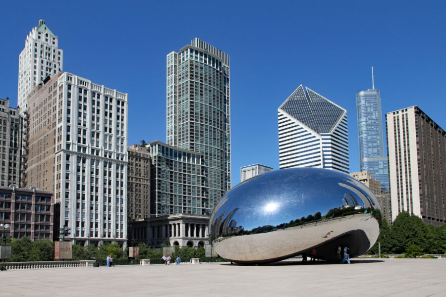 Cloud Gate sculpture, known as the bean, reflecting Chicago's skyline in the background on a clear day