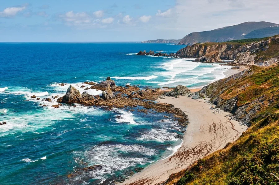 Turquoise sea and rugged coastal cliffs in Costa da Morte, Spain.