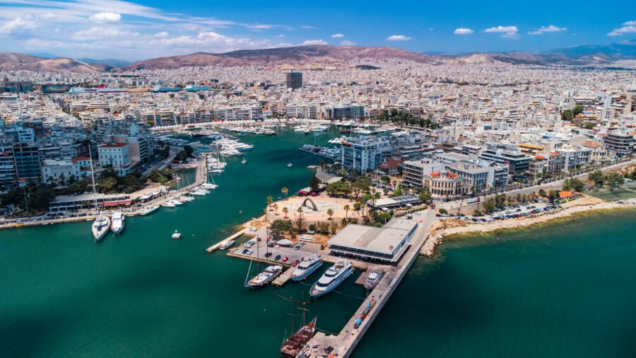 Aerial view of Piraeus harbor, Athens marina with yachts and coastal city waterfront.
