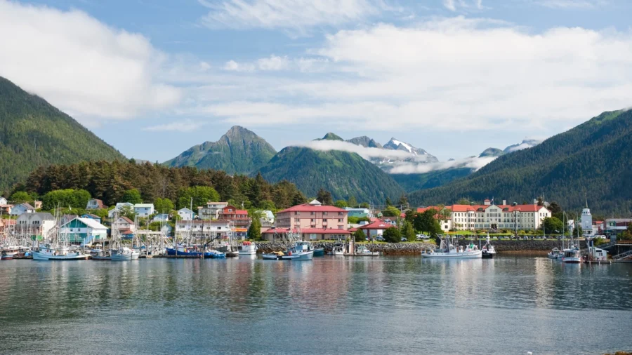 Sitka, Alaska coastal harbor with boats, waterfront town, and forested mountains.