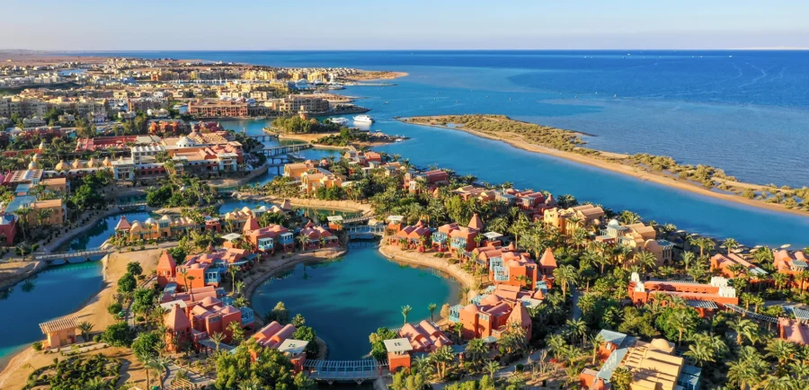 Aerial view of El Gouna Egypt coastal resort town with turquoise lagoons, hotels, and desert backdrop.