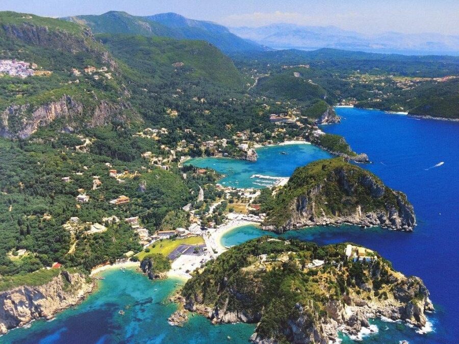 Aerial view of Mediterranean beaches, turquoise waters, lush hills, and quaint coastal villages.
