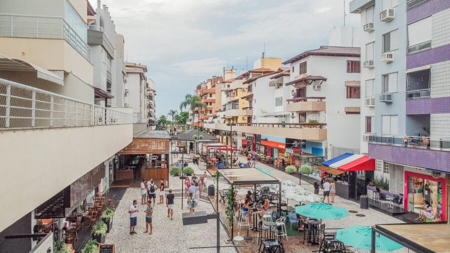 Coastal pedestrian shopping street with outdoor cafes, restaurants and apartments in Jurerê, Brazil.