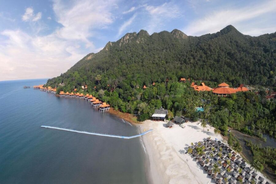 Aerial view of a Pantai Kok tropical beach resort with white sand and overwater villas.