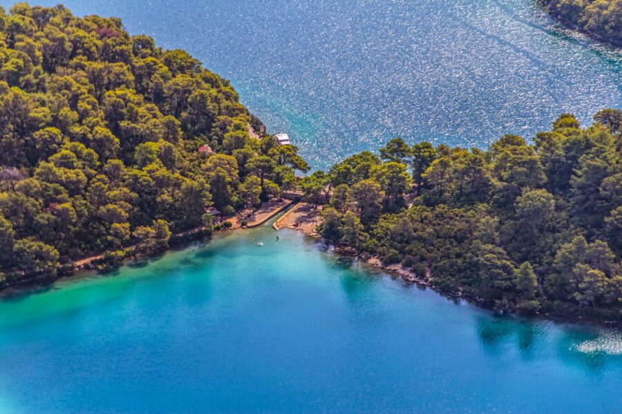 Aerial view of Mljets Veliko Jezero with lush island and tranquil waters.