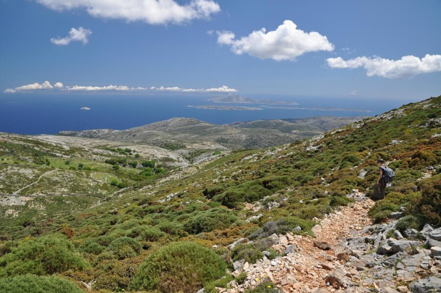 Mount Zas coastal rocky trail with lone hiker and sea view over distant islands.