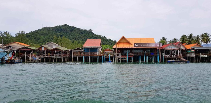 Colorful tropical stilt houses over water in Saladan Village, Thailand fishing waterfront.