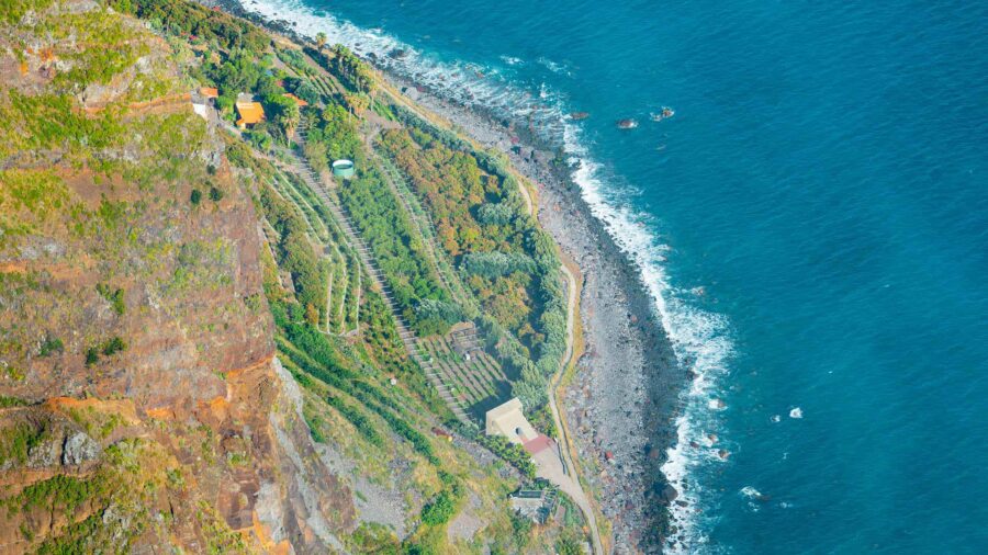 Cabo Girao terraced cliffs overlooking turquoise Atlantic Ocean.