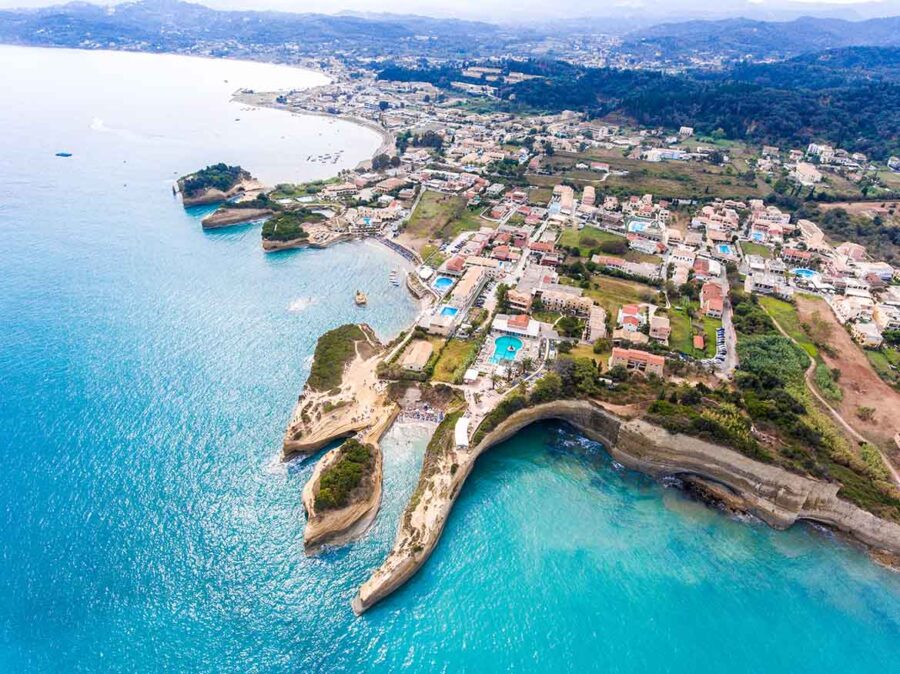 Aerial view of Sidaris stunning coastline with cliffs, turquoise waters, and vibrant community.