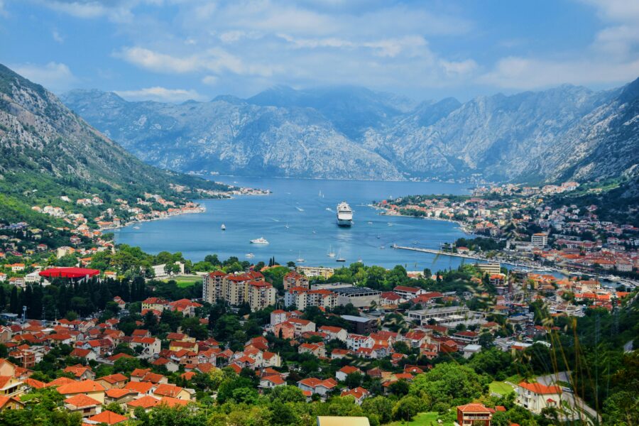 Kotor Bay, Montenegro: terracotta-roofed coastal town with cruise ship and mountains.