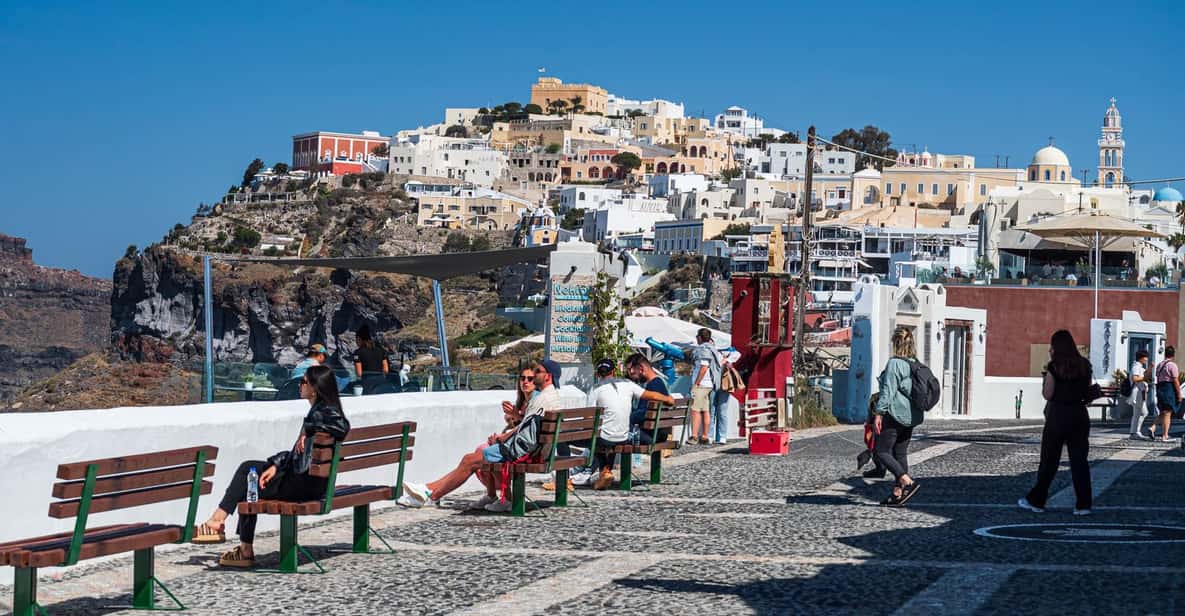 Santorinis vibrant architecture and lively streets with tourists enjoying picturesque views.
