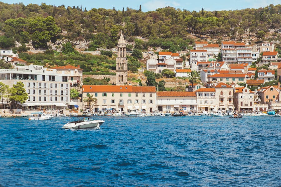 Hvar, Croatia Dalmatia coastal town marina with bell tower and Adriatic boats.