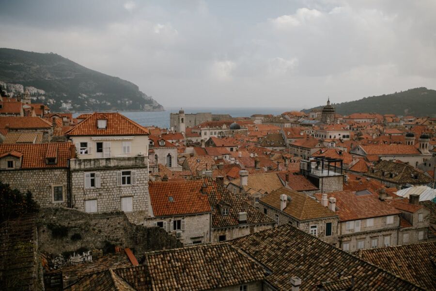 Panoramic Centro Storico coastal town, historical architecture, terracotta rooftops, sea view, natural backdrop.