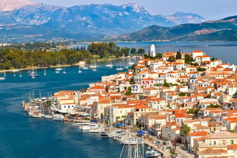 Picturesque Mediterranean coastal town with white buildings, terracotta roofs, and tranquil bay.