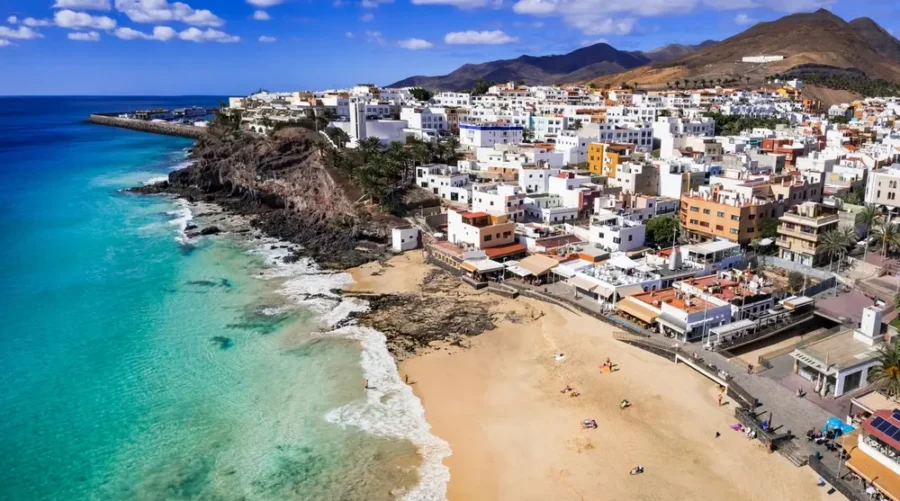 Aerial view of Fuerteventura coastal village and turquoise beach, Canary Islands.