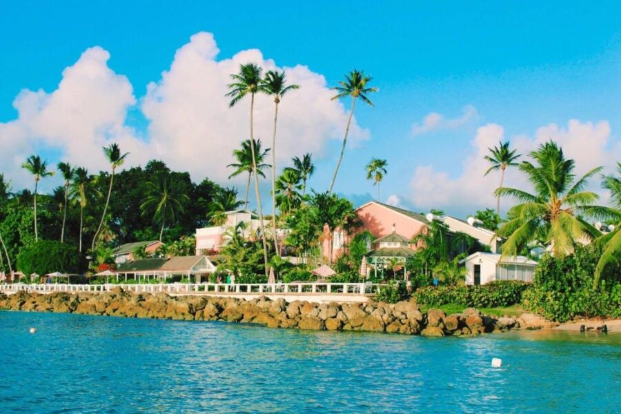 Cobblers Cove resort in Barbados, showcasing palm trees and a serene waterfront landscape.