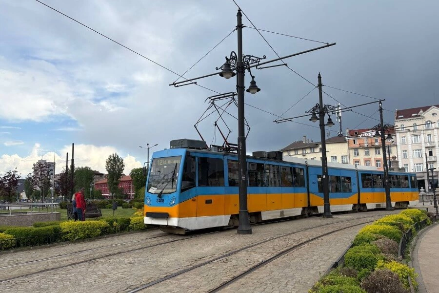 Modern tram in Sofia cityscape, blending vibrant colors with urban and natural elements.