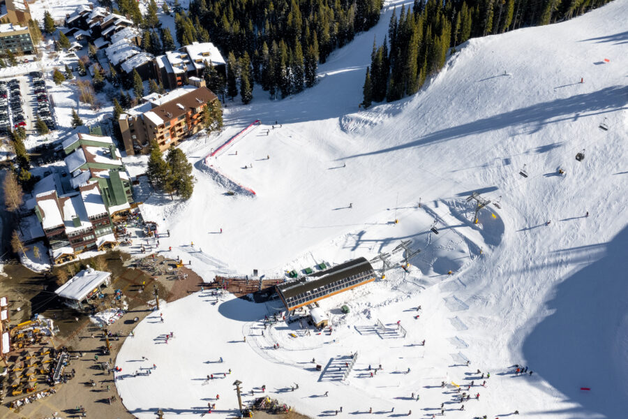 Aerial view of winter sports and recreation at Copper Mountain, Colorado, showcasing snow-covered slopes and falling snow.