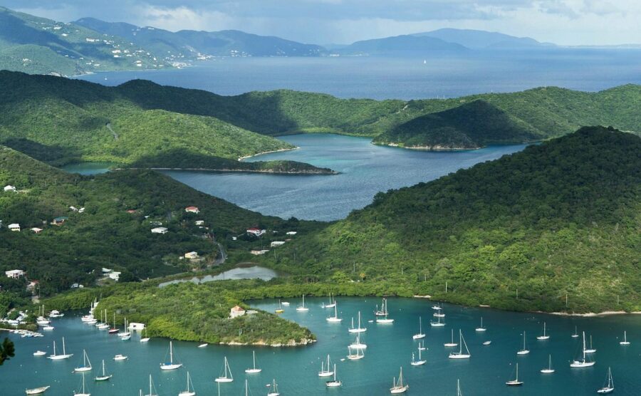Scenic view from a hilltop overlooking Coral Bay, St. John, U.S. Virgin Islands, with lush greenery and sparkling water.