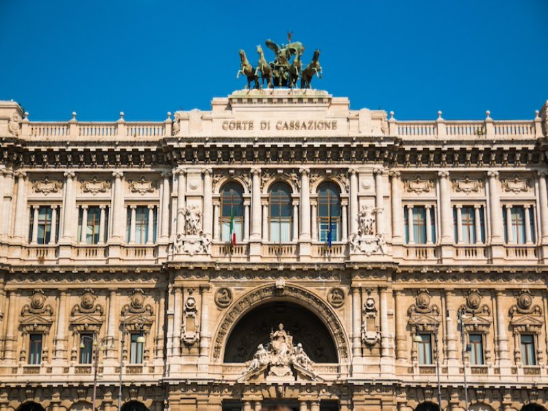 Italian Court of Cassation façade, neoclassical stone building with bronze quadriga and sculptures.