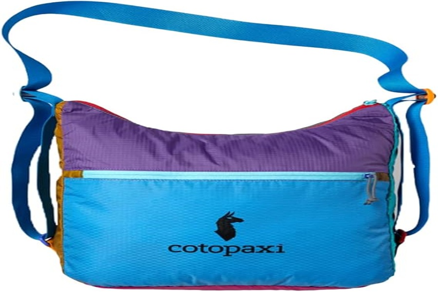 Cotopaxis colorful, sustainable shoulder bag with patchwork design, spacious compartment, adjustable strap.