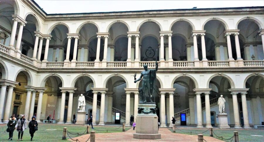 Renaissance-style courtyard with statue, columns, arches