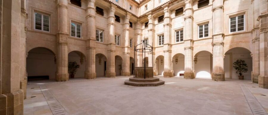 Stone arcade courtyard with central well at Museu de Menorca.
