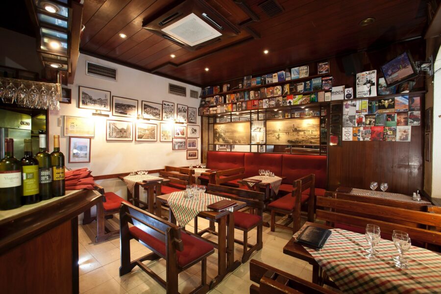 Cozy restaurant interior with rustic decor, warm lighting, and intimate dining setup.
