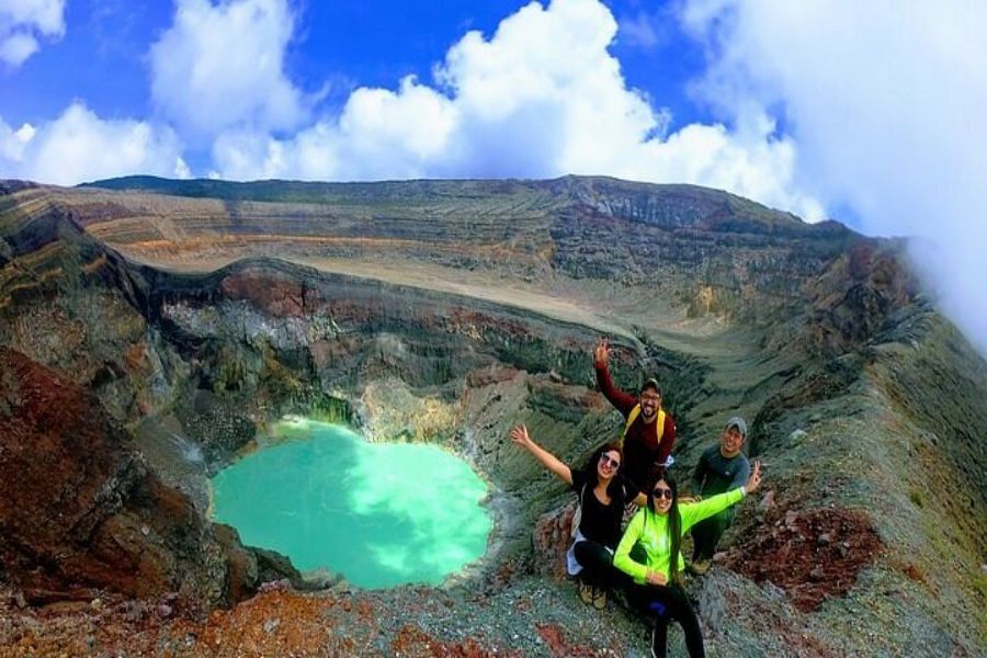 Adventure group at Santa Ana Volcano crater, El Salvador, vibrant crater lake and dramatic landscape.