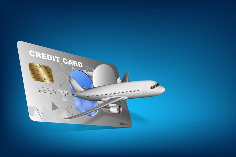 Silver credit card with airplane, blue background, travel rewards, luxury finance theme.