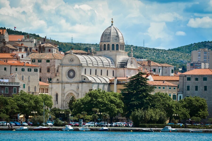 Scenic view of Sibenik coastal city, showcasing St. James Cathedral and vibrant architecture.